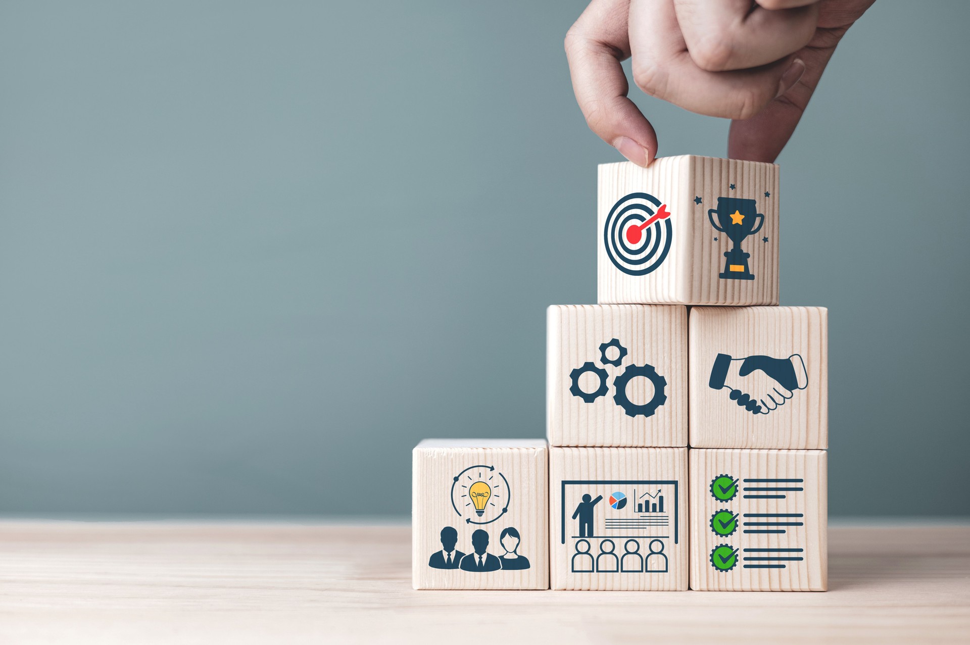 Concepts and methods for developing organizations towards success. Business icons on wooden blocks