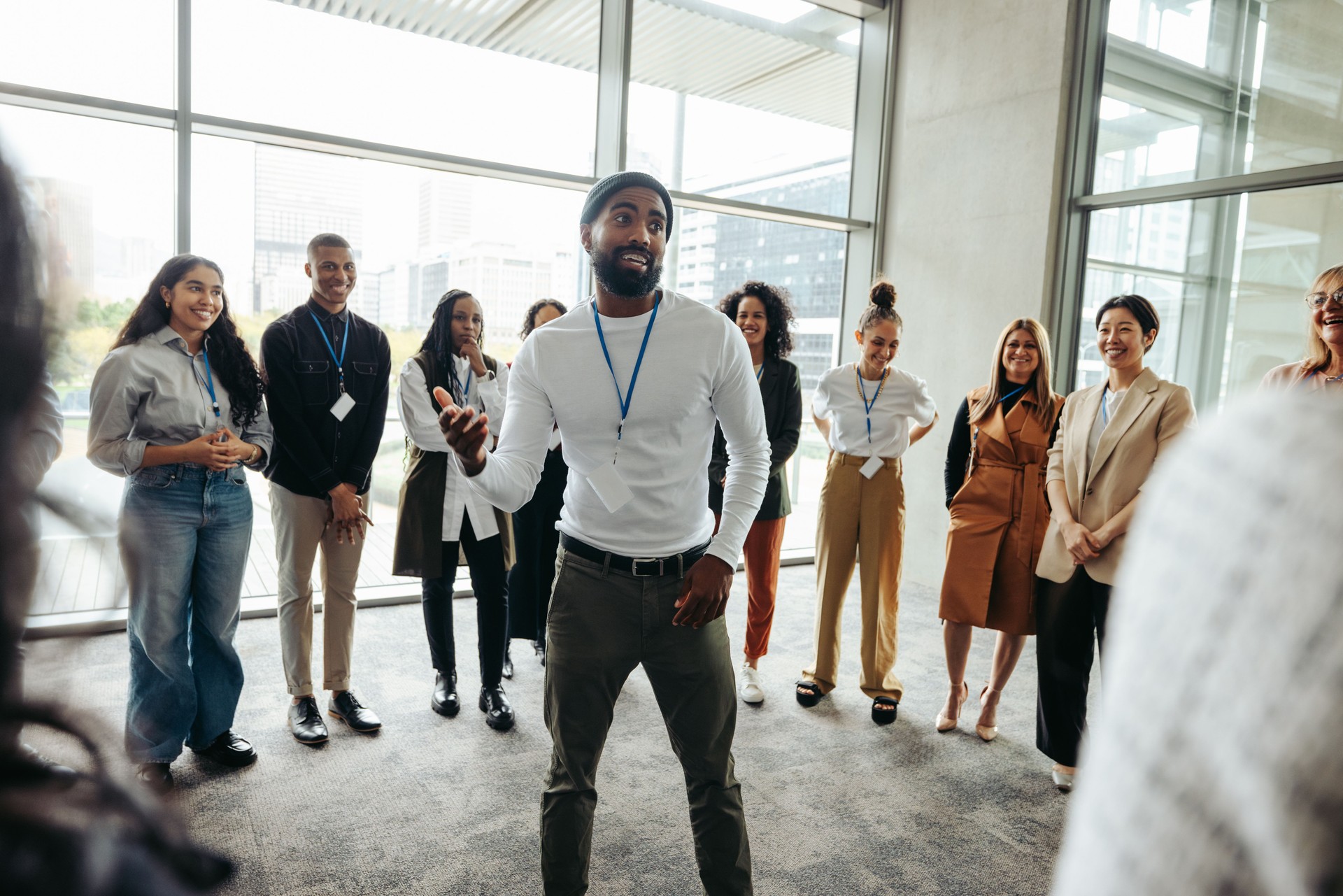 Confident businessman leading an engaging team-building session in a modern office